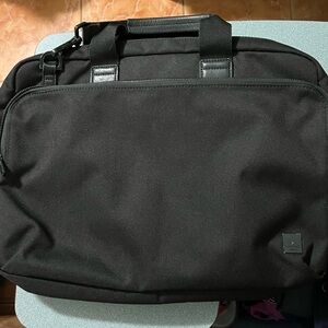 KNOMO Black Unisex Laptop Briefcase Messenger Bag with many compartments.